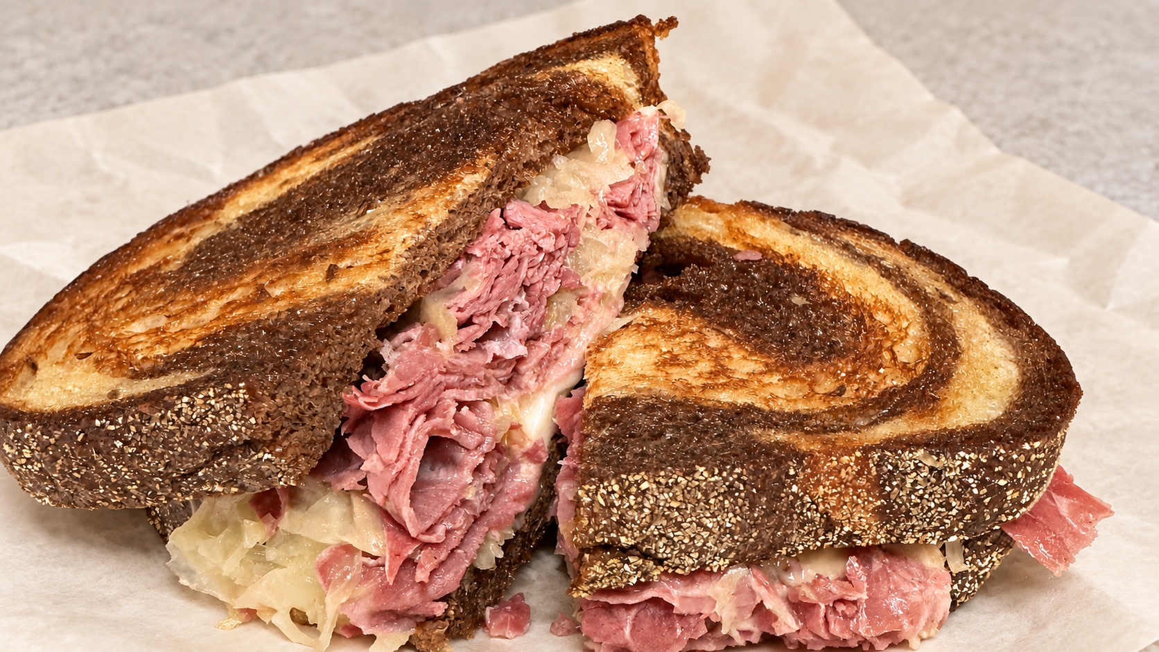 Grilled Reuben sandwich with corned beef, sauerkraut, and melted cheese